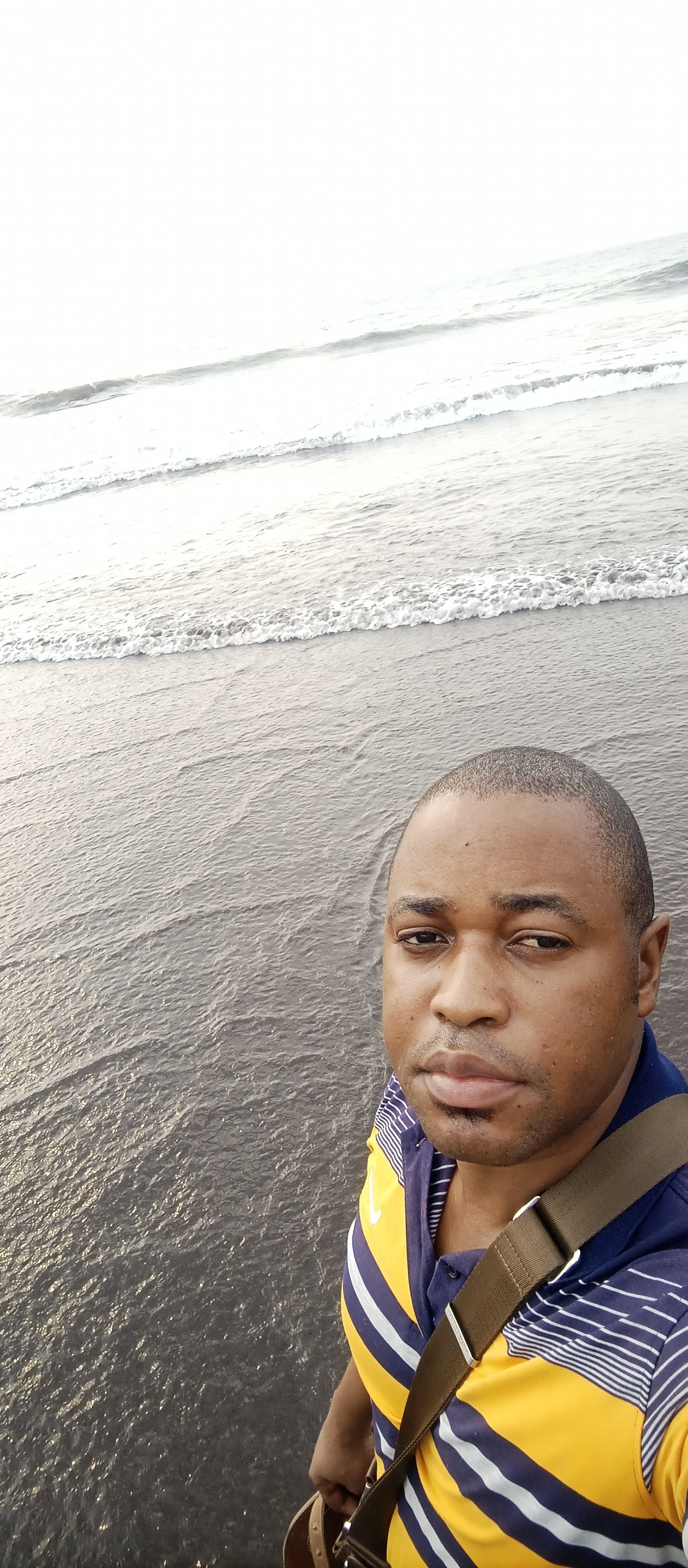 Close-up underwater portrait of a young. Light rays from the water surface create bright, wavy refle